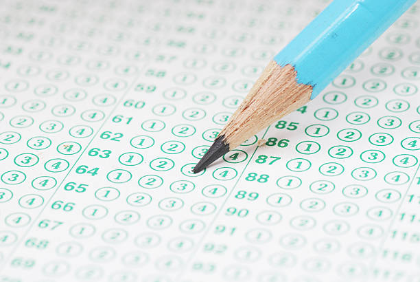 istock Pencils on blank test sheet close up 613860996