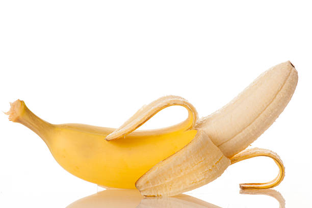 istock Pilled sweet banana isolated over white background 613861074