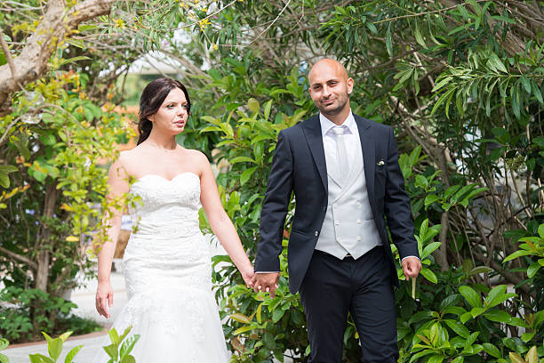 istock married couple walking in garden 613863180