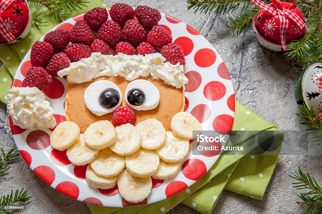 Santa pancake with raspberry for kid breakfast Christmas Santa pancake with raspberry and banana for kid breakfast Baby - Human Age Stock Photo