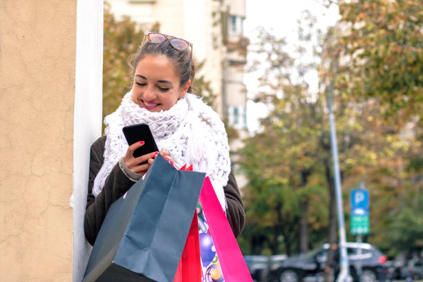 istock Shopping woman using app on her phone 613865846