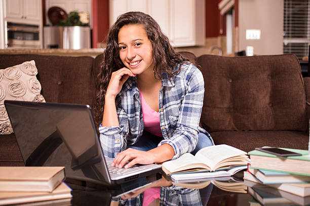 istock Teenage girl studying or doing homework at home 613867390