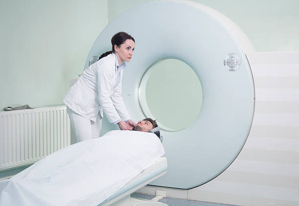 istock Radiologic technician and Patient being scanned and diagnosed on CT 613869382