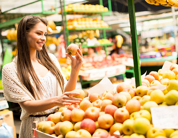 istock Young woman at market 613871722