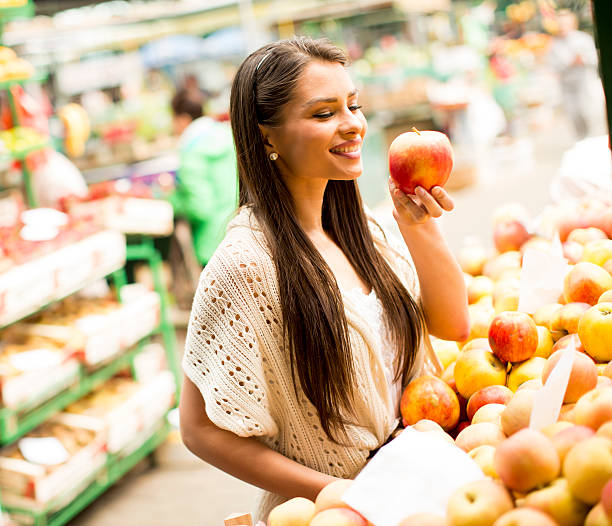 istock Young woman on market 613871758