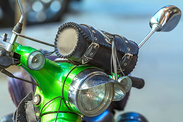 istock headlight of a moped, green 613871764