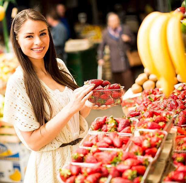 istock Young woman at market 613871768