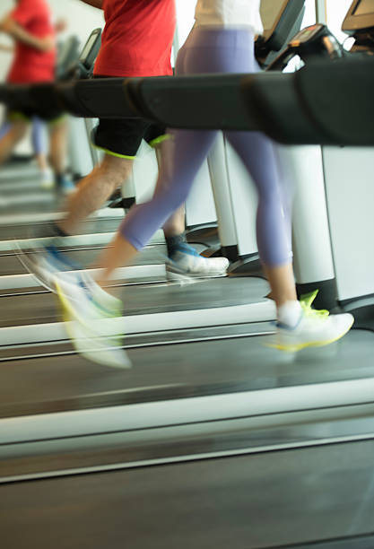 istock Woman and man running on treadmill 613872066