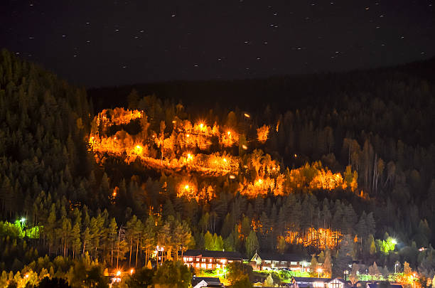 istock serpentine mountain road illuminating night light, norway 613872240