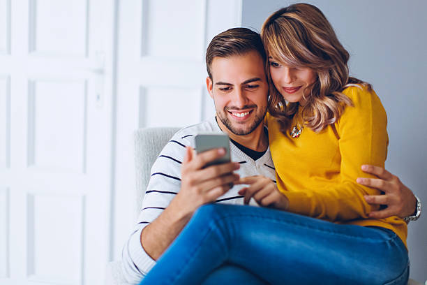 istock Couple having fun on smart phone 613872426
