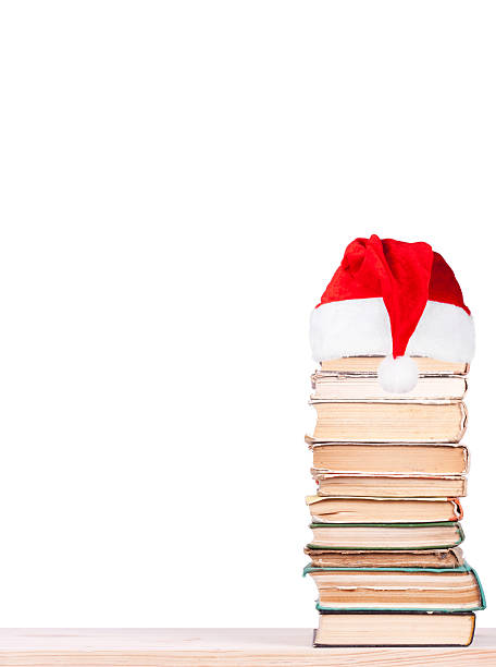 istock Old books on shelf in santa hat. 613872476