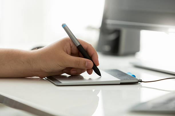 istock Closeup of professional designer using graphic tablet at work 613873012