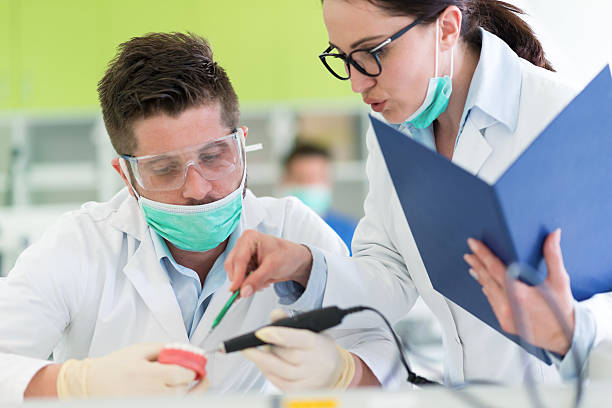 istock Busy young stomatology students working carefully on anatomical models 613873076