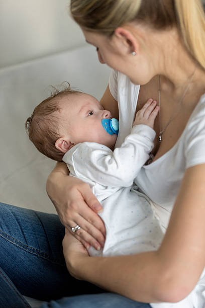 istock Beautiful mother rocking her cute baby on hands 613873304