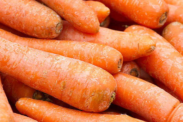 istock Carrot red background. Fresh organic vegetables 613873734