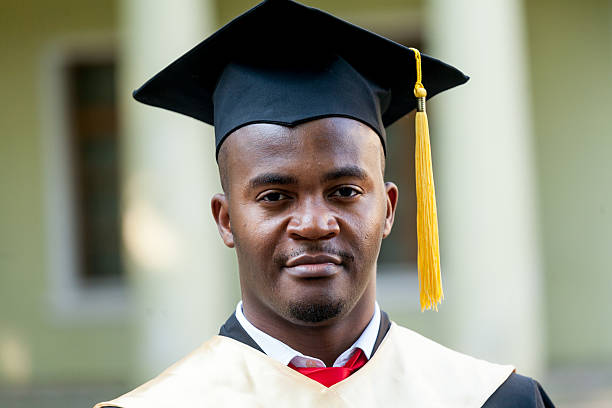 istock Graduate students wearing graduation hat and gown 613874088