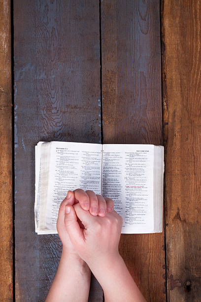 istock The prayer on the Bible. 613874218