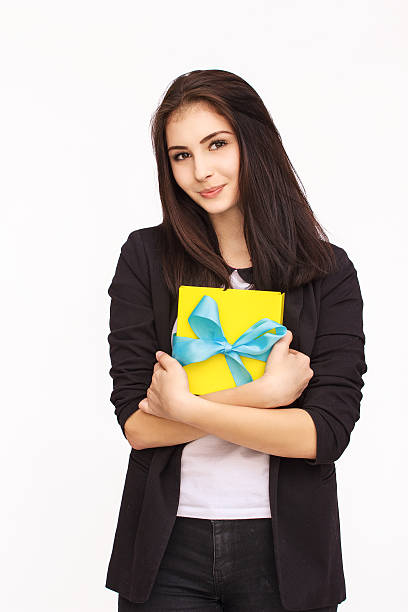 istock Young woman portrait holding gift 613875300