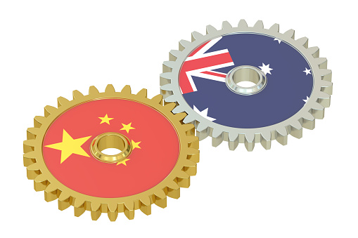 Chinese and Australian flags on a gears, 3D rendering isolated on white background