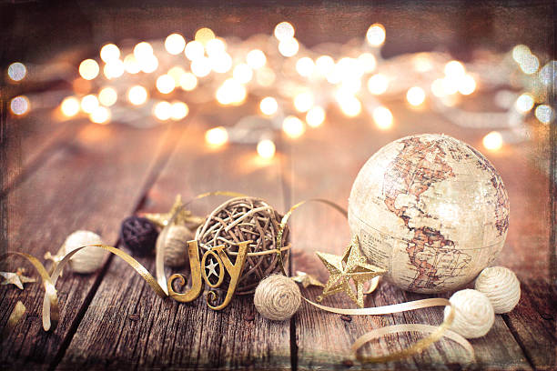 Environmentally Friendly Christmas Decorations and Globe on Old Wood Background