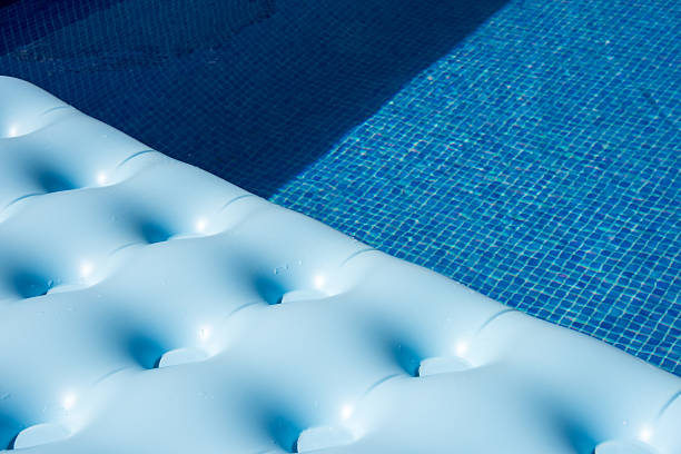istock blue air bed mattress in swimming pool 613877508