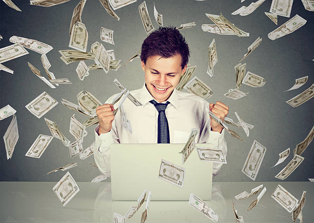 istock man using laptop building online business under money rain 613877634