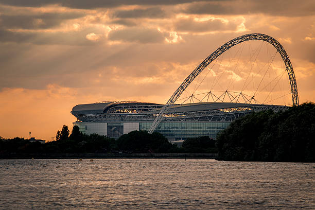 London, UK - October 6, 2016: The wembley stadium from across the reservoir at sunset. Wembley is the English national stadium in London, England
