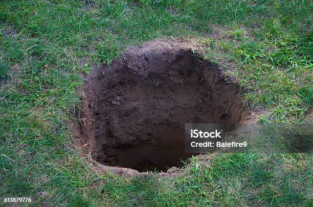 Deep Dirt Hole In Ground Or Lawn Stock Photo - Download Image Now - Hole, Land, Dirt