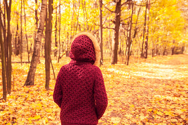 istock Woman in autumn park 613880274