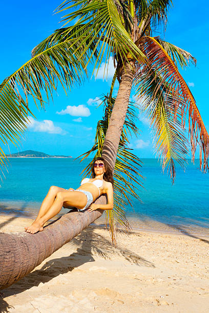 istock Woman at tropical beach 613881036