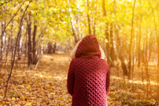 istock Woman in autumn park 613881852