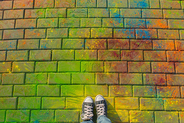 istock Feet in jaeans sneaker top view on the holi background.. 613882330