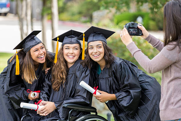 istock Cheerful diverse college friends after graduation 613884670