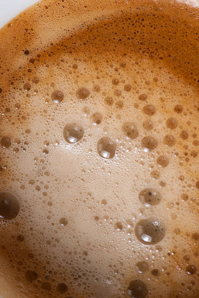 istock coffee foam closeup macro top view background texture 613885368