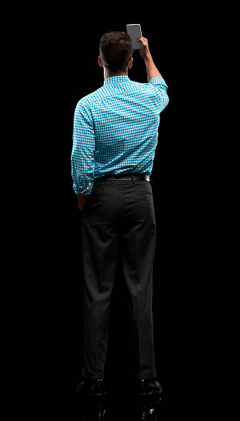 istock Rear view of businessman taking a selfie 613885434