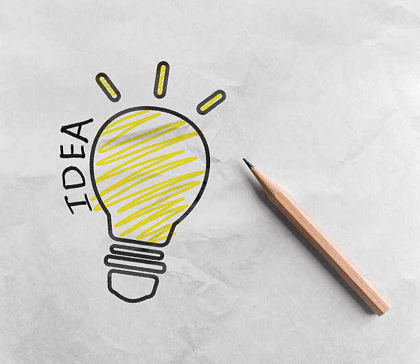 istock Pencil drawing light bulb on white paper 613885612