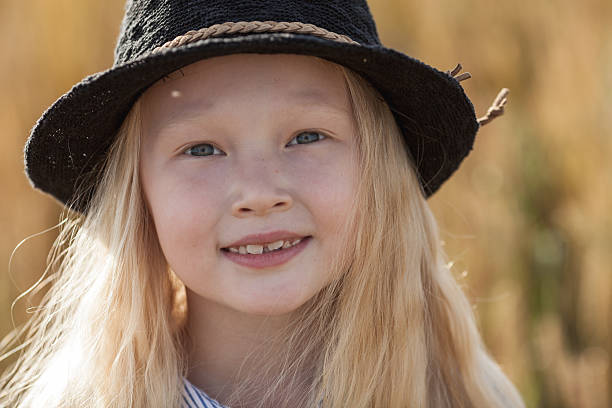 istock girl in wheat field 613886504