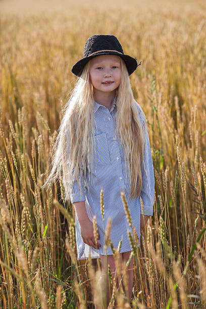 istock girl in wheat field 613886566