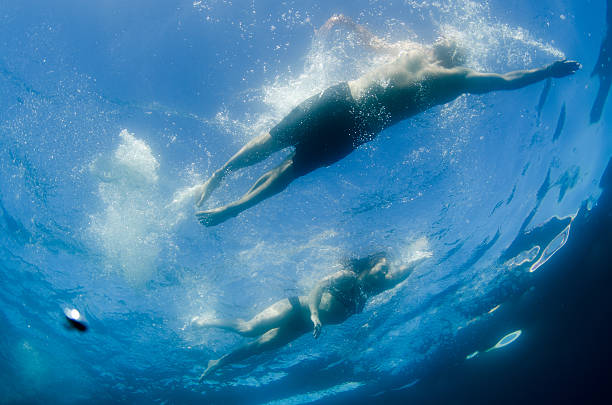 istock couple swimming 613886606