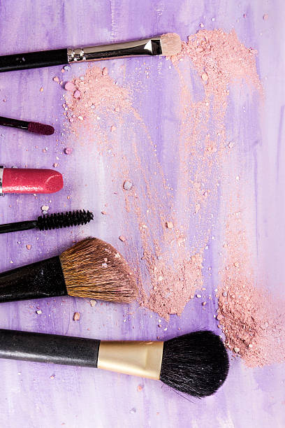 istock Makeup brushes and lipstick on light purple background 613886662