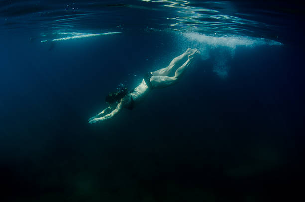 istock Woman diving into dark waters 613886720