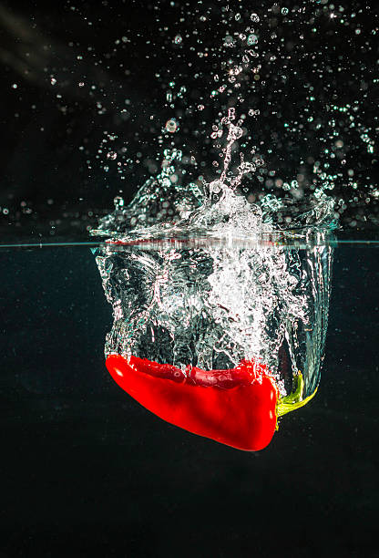 Close view of red pepper in front of kitchen window