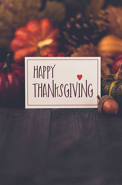 istock Thanksgiving still life background with pumpkins, acorns and message 613887166