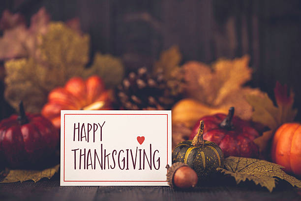 istock Thanksgiving still life background with pumpkins, acorns and message 613887208