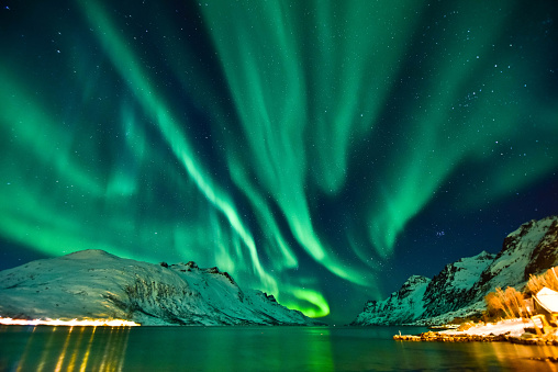 The aurora in front of the Norwegian fjord at Tromso, Norway.