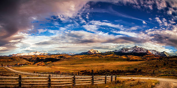 Winding Mountain Trail Winding mountain trail at autumn.  The scene is Mount Wilson in Colorado's San Juan Mountains. panoramic country road single lane road sky stock pictures, royalty-free photos & images