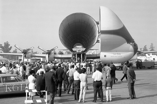 Van Nuys, California, USA - July 3, 1965: A crowd gathers around the Aero Spacelines Super Guppy airplane, tail number N1965C, being displayed at the annual Van Nuys Aviation Expo (air show). One use of the Super Guppy with its oversized cargo bay was to ferry rocket sections from California to Florida for the space program. Scanned film.