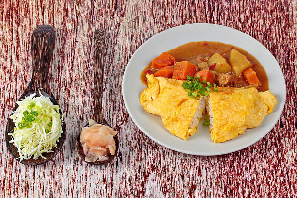 istock Omelet rice topped yellow curry. 613889024