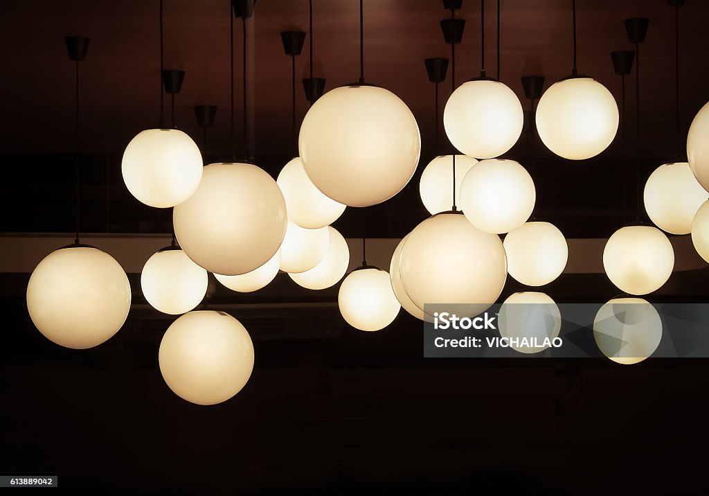 Lighting ball hanging from the ceiling Lighting ball hanging from the ceiling on the black background Electric Lamp Stock Photo
