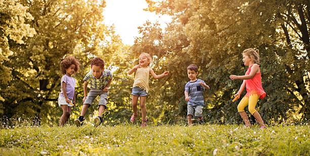 istock Group of playful kids having fun while skipping jump rope. 613890032